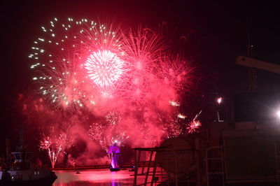 Low angle view of firework display at night