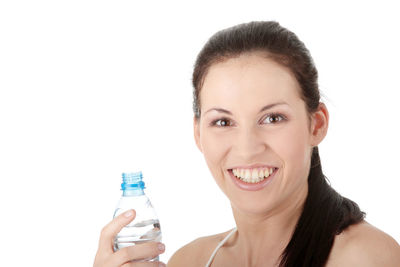 Portrait of a smiling young woman over white background