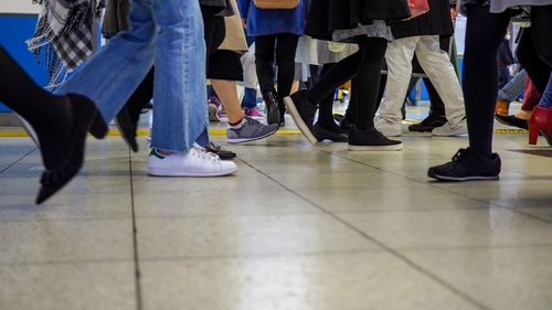 Low section of people on tiled floor