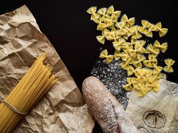 High angle view of fresh yellow flowers on table against black background