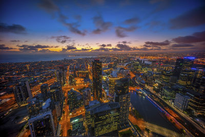 Aerial view of city lit up at night