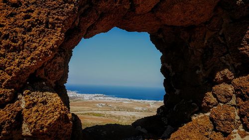 Scenic view of sea seen through cave