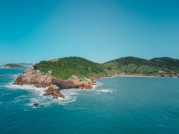 Scenic view of sea against clear blue sky