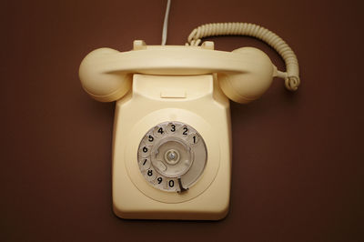 Close-up of rotary phone on table