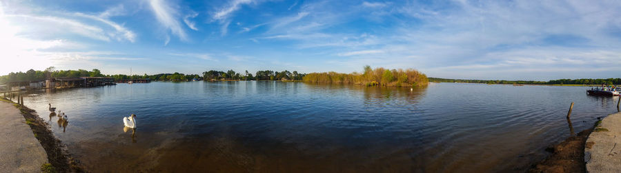 Scenic view of lake against cloudy sky