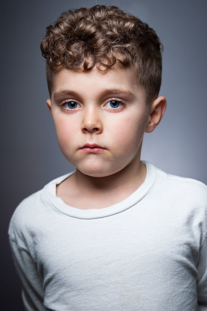 portrait, looking at camera, person, childhood, front view, headshot, lifestyles, cute, studio shot, innocence, indoors, elementary age, close-up, casual clothing, leisure activity, boys, smiling