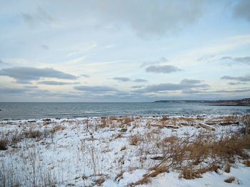 Scenic view of sea against sky during winter