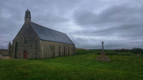 High angle view of church against cloudy sky