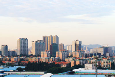 Buildings in city against sky