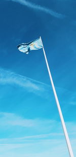 Low angle view of crane against blue sky