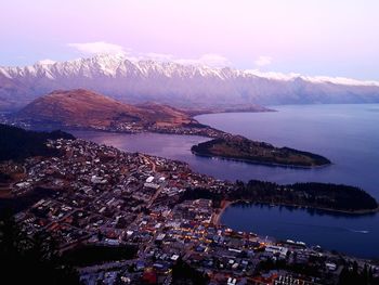 High angle view of townscape by sea against sky