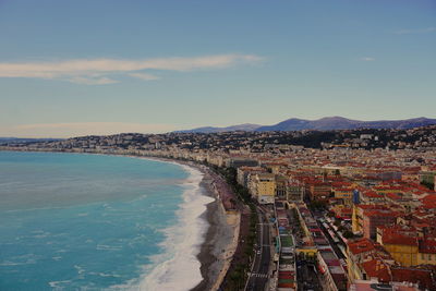 High angle view of sea and buildings against sky