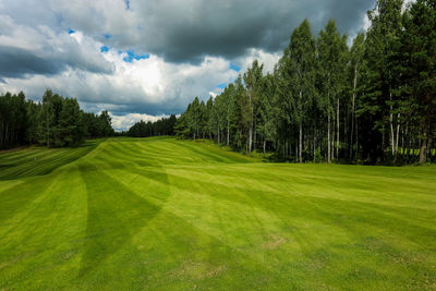 Panoramic view of golf course against sky