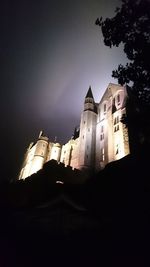 Low angle view of illuminated buildings against sky at dusk