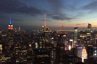 Illuminated cityscape against sky at night