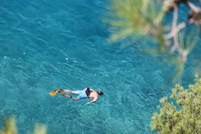 High angle view of man swimming in sea