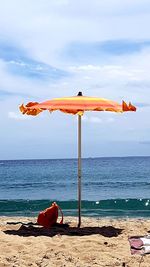 Lifeguard hut on beach against sky