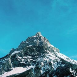 Low angle view of snow covered mountains