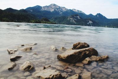 Scenic view of rocks in lake against sky