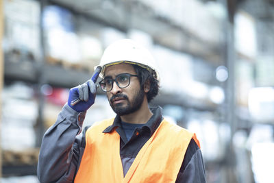 Young store worker looking in a hall