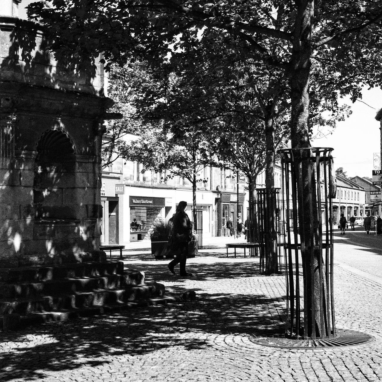 architecture, built structure, tree, building exterior, city, men, person, walking, lifestyles, park - man made space, incidental people, day, statue, footpath, sunlight, shadow, rear view, leisure activity