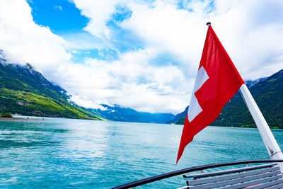 Red flag on mountain against sky