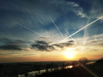 Silhouette landscape against sky during sunset