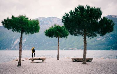 Man standing on beach against sky