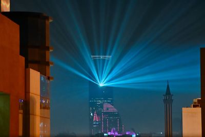 Rays of light illuminating from the kingdom tower at night. 