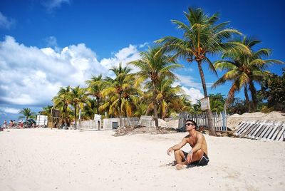 Young man sitting on beach