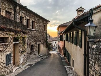 Street amidst buildings against sky