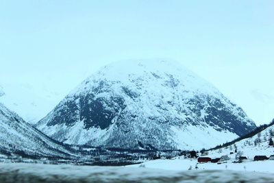 Close-up of snow on mountain against clear sky