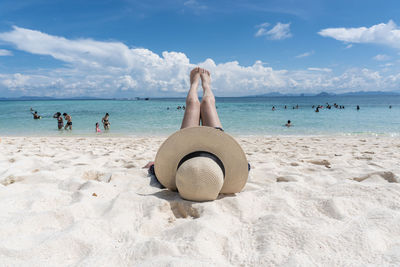 People on beach against sky