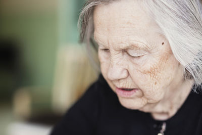 Close-up of thoughtful senior woman at nursing home