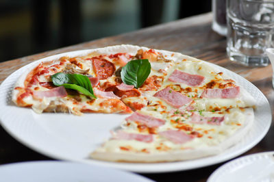 Close-up of pizza served on table in restaurant