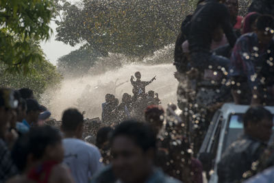 People enjoying water splash at festival