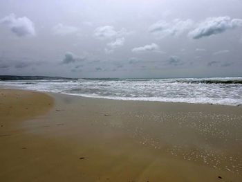 Scenic view of sea against cloudy sky