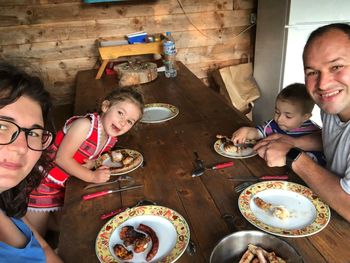 High angle view of friends sitting on table