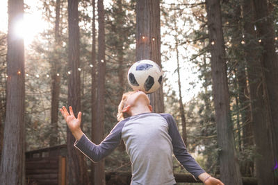 Boy playing with soccer ball at park