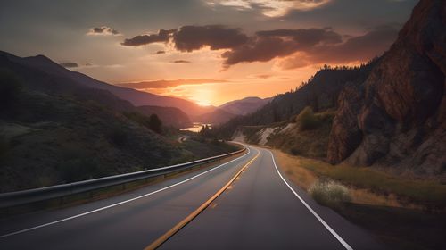 Empty road against sky during sunset