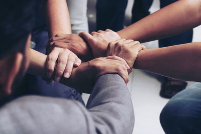 Cropped image of friends with holding hands