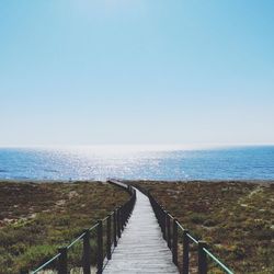 Narrow jetty leading to calm lake