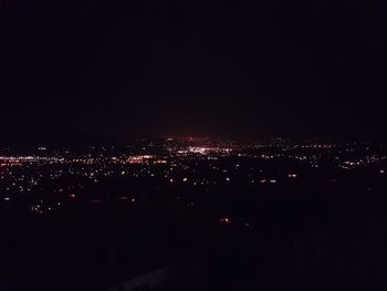 High angle view of illuminated buildings in city at night