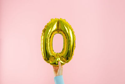 Close-up of green leaf against colored background