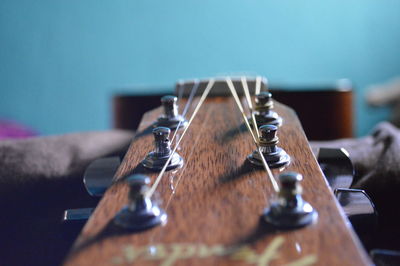 Close-up of guitar on bed