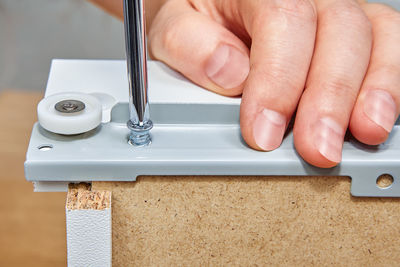 Close-up of person holding hands on table