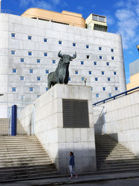 Low angle view of sculpture on staircase of building