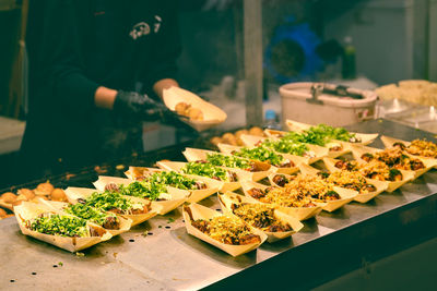 Chief making takoyaki, octopus ball under food stall in japan