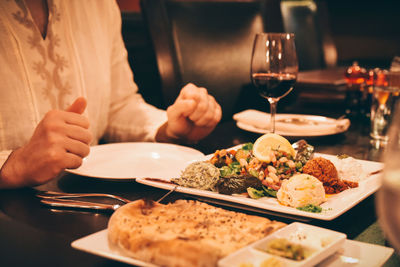 Midsection of man having food in restaurant