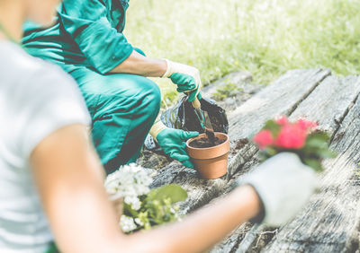 Midsection of woman holding plant